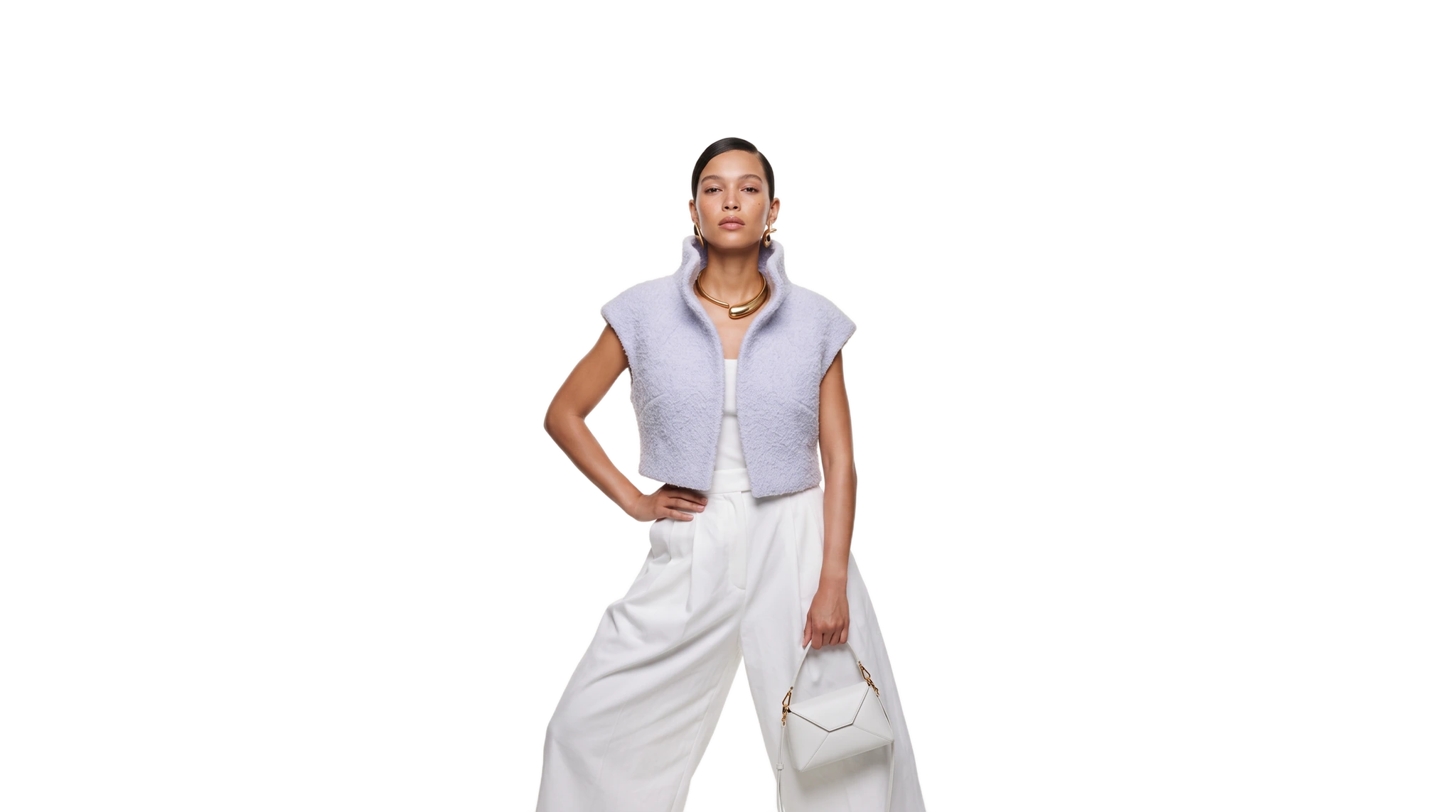 A model in a cropped lilac bouclé vest with a high collar and wide white trousers, holding a small white handbag, cut out on a plain ground
